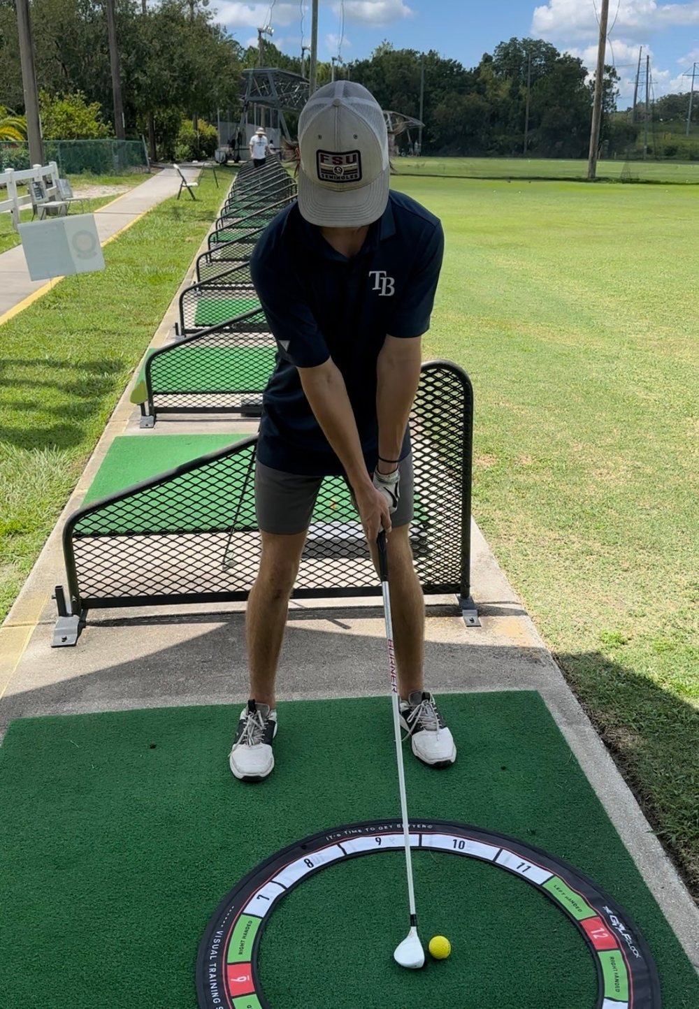 Golfer set up with The Golf Clock at the driving range