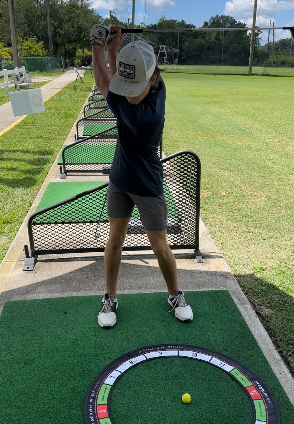 Golfer taking the club back over the Golf Clock