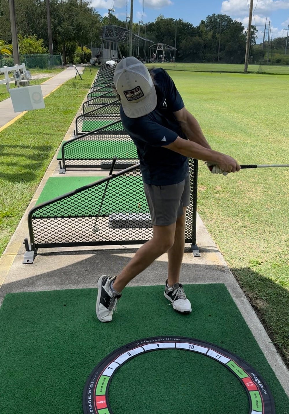 Golfer releasing over the green marker on The Golf Clock